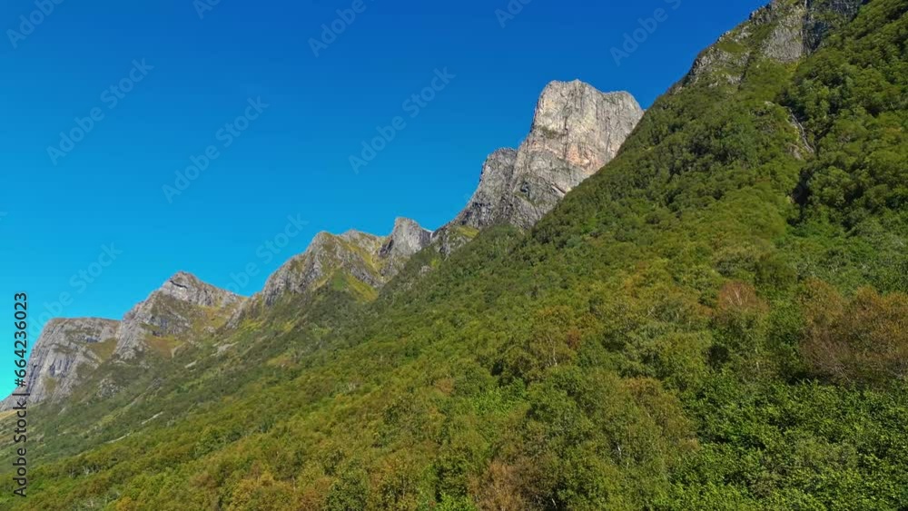 Aerial of the peaks and hills around Rovde near Syvdefjorden in the Vanylven Municipality, Norway. Drone dolly forward shot