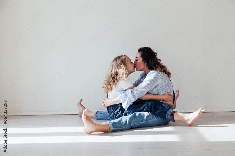 Mom and daughter hugging love family in bright room Mom and daughter hugging love family in bright room