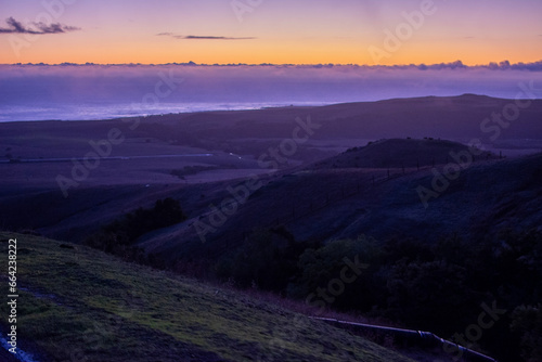sunset in the mountains along winding road in California 