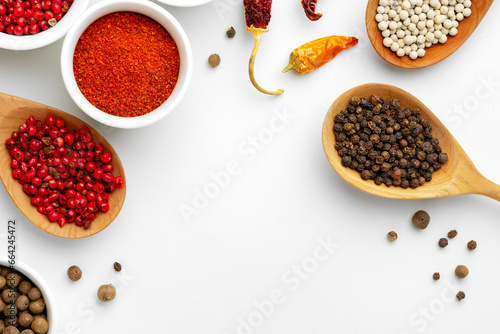 Composition with different aromatic spices in bowls and wooden spoons on white background