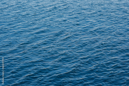 Sea surface with gentle ripples and light refracting on the surface