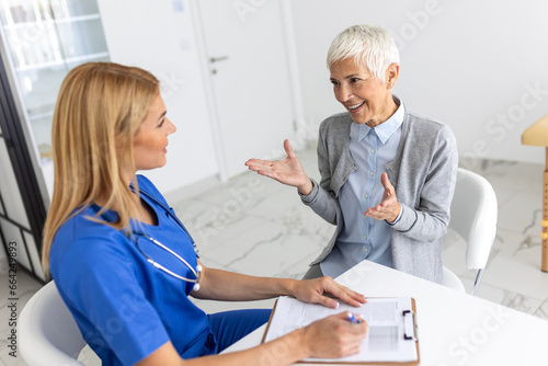 Healthcare and medical concept - doctor with patient in hospital. Doctor working in the office and listening to the patient, she is explaining her symptoms, healtcare and assistance concept