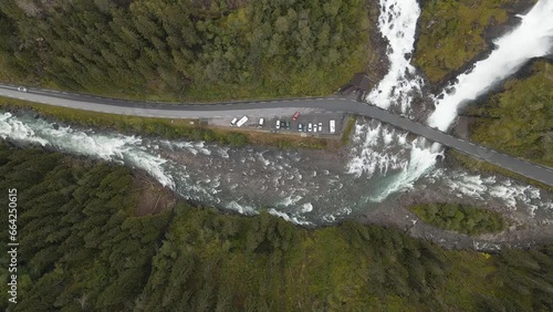 Cars driving over bridge in Norwegian highlands, Latefossen Waterfall, aerial photo