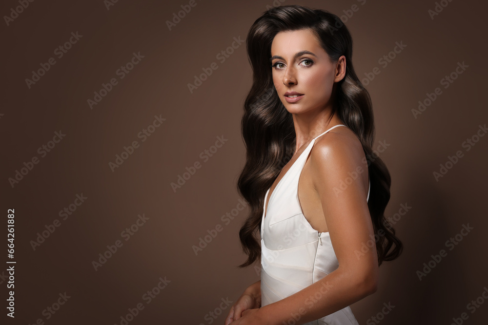 Gorgeous woman with shiny wavy hair on brown background, space for text. Professional hairstyling Gorgeous woman with shiny wavy hair on brown background, space for text. Professional hairstyling