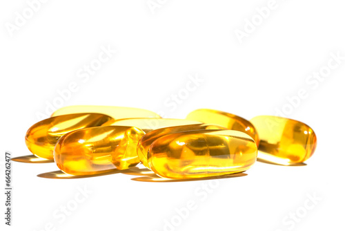 Pile of golden color oil in soft gel capsule isolated on white background. oil supplements in soft gel capsule, healthy product concept