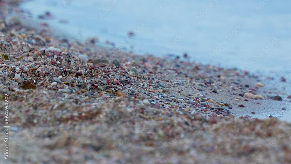 Soft Focus Close View of Pebbled Beach with Small Waves Out of Focus