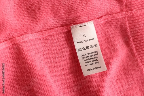 Clothing label on coral garment, top view