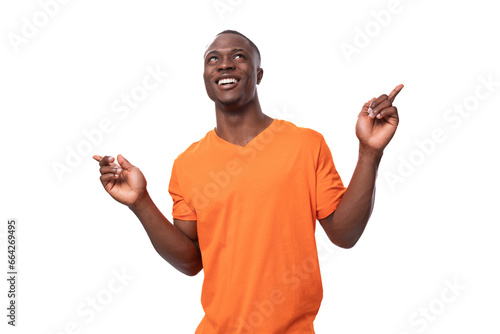Εκτύπωση καμβά young happy american man dressed in basic orange t-shirt experiencing joy on whi