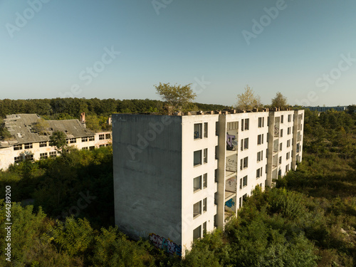 Abandoned residental area and buildings. It looks like  Ghost town of Pripyat, Chernobyl zone, Ukraine. People left this place a long time ago.  Houses are destroyed, abandoned and ruined. photo