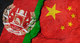 Afghanistan and China flags, concrete wall texture with cracks, grunge background, military conflict concept