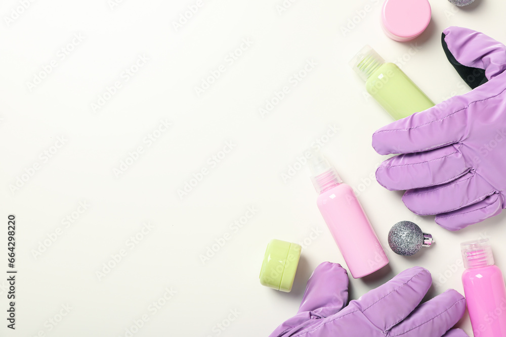 Cosmetic bottles and jars, ski gloves on white background, space for text Cosmetic bottles and jars, ski gloves on white background, space for text