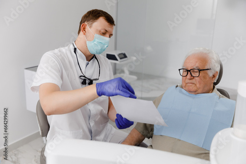 Modern dentist clinic old man have a checkup appointment he laying down on the dentist chair concept of healthcare and medical clinic