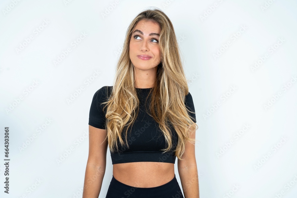caucasian woman wearing sport clothes looking aside into empty space thoughtful caucasian woman wearing sport clothes looking aside into empty space thoughtful