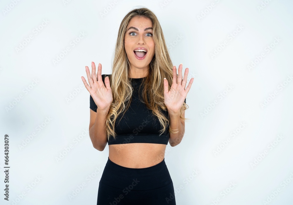 Optimistic caucasian woman wearing sport clothes raises palms from joy, happy to receive awesome present from someone, shouts loudly, Optimistic caucasian woman wearing sport clothes raises palms from joy, happy to receive awesome present from someone, shouts loudly,