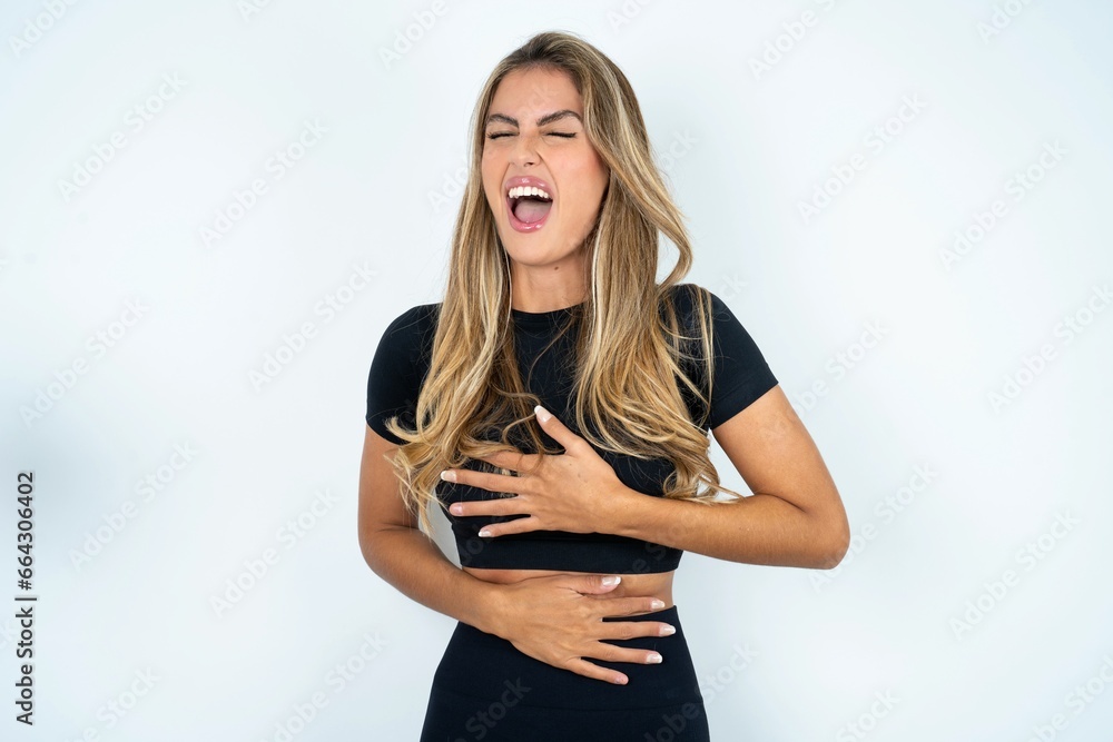 Φωτογραφία Young beautiful woman wearing sport clothes smiling and laughing hard out loud because funny crazy joke with hands on body