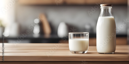 Wooden tabletop counter with Bottle and glass of tasty milk. in front of bright out of focus kitchen. copy space