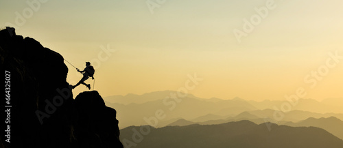 Athlete Climbing to the Summit Accompanied by a Wonderful View photo