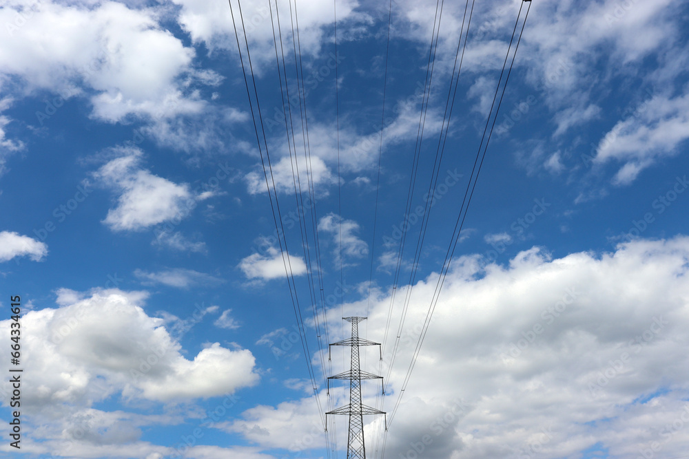 Masten einer Überlandleitung vor leicht bewölktem Himmel Masten einer Überlandleitung vor leicht bewölktem Himmel
