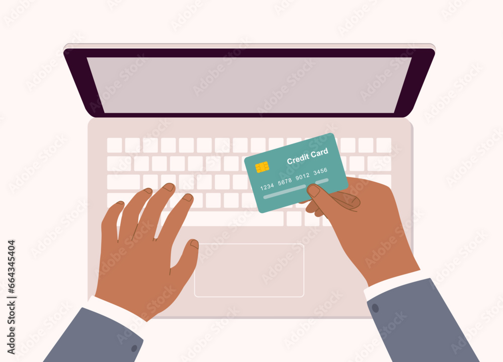 Black Male’s Hand Holding A Credit Card With Laptop. Close-Up. Black Male’s Hand Holding A Credit Card With Laptop. Close-Up.