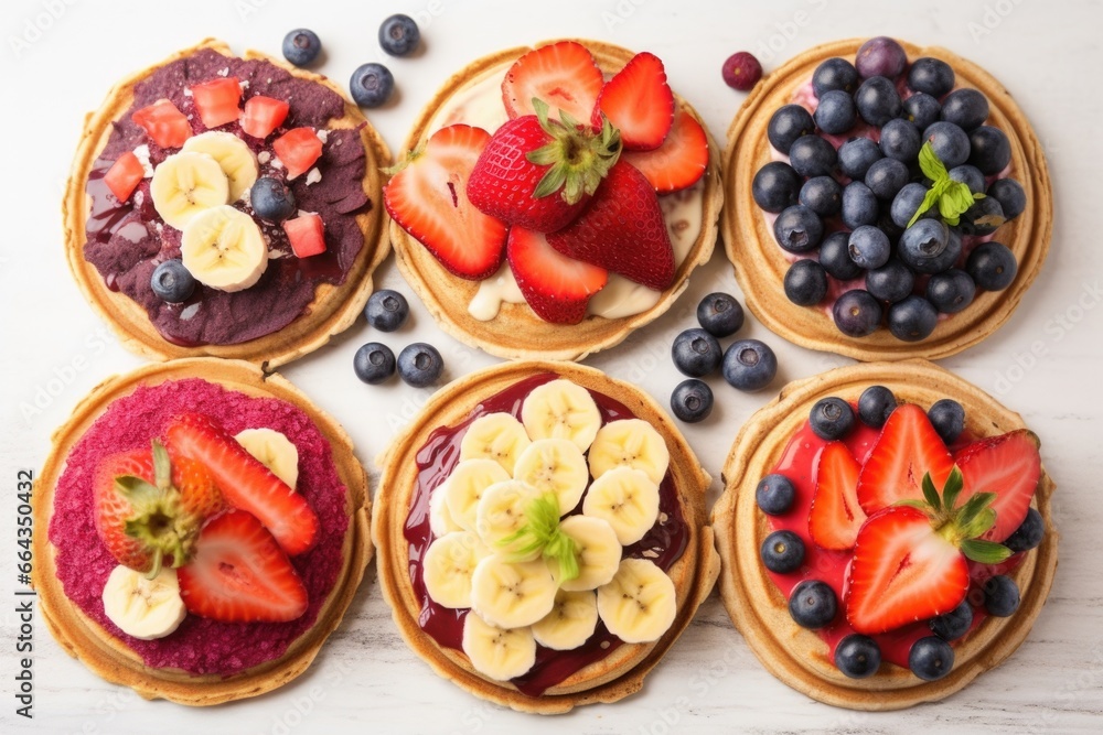grid of vegan pancakes topped with various fruits: strawberry, blueberry, banana