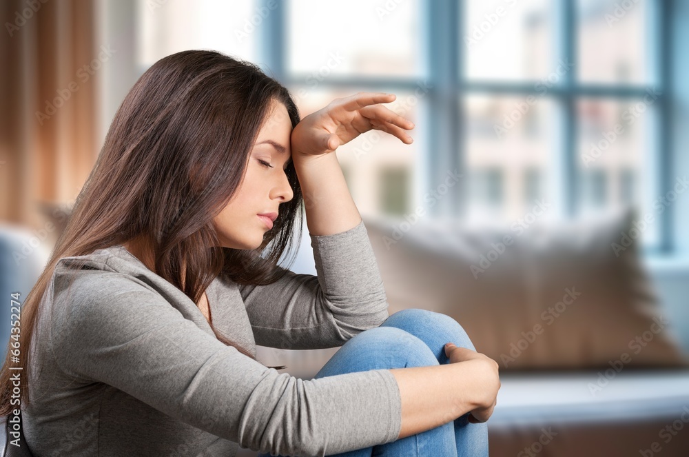 Sad depressed person sitting on sofa at home, AI generated image Sad depressed person sitting on sofa at home, AI generated image