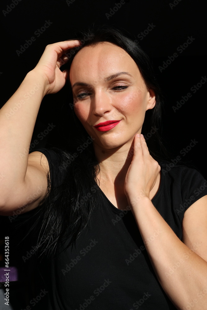 A very delicate and well-groomed female face in the sun. A very delicate and well-groomed female face in the sun.