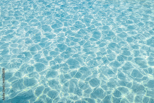 Surface of blue swimming pool  background of water in swimming pool. Blue ripped water in swimming pool. Abstract summer background concept. Fun relaxation carefree copy space wallpaper