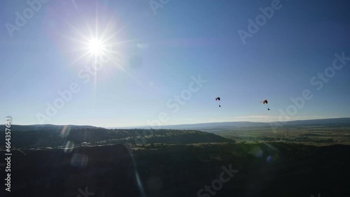 Wide shot over desert with paragliders - drone shot