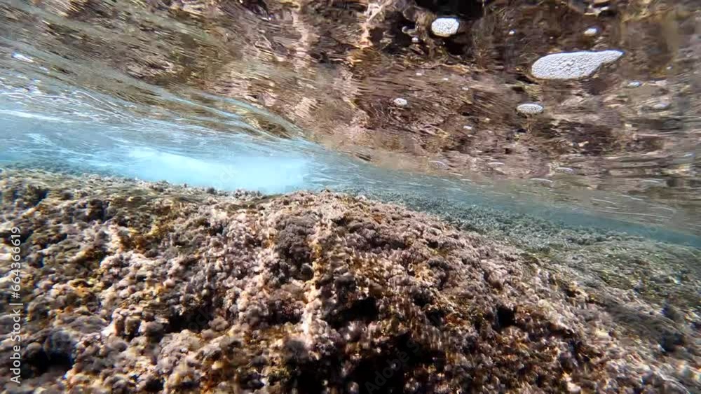 Underwater view waves crash on rocky coast. Slow motion 4K Underwater view waves crash on rocky coast. Slow motion 4K