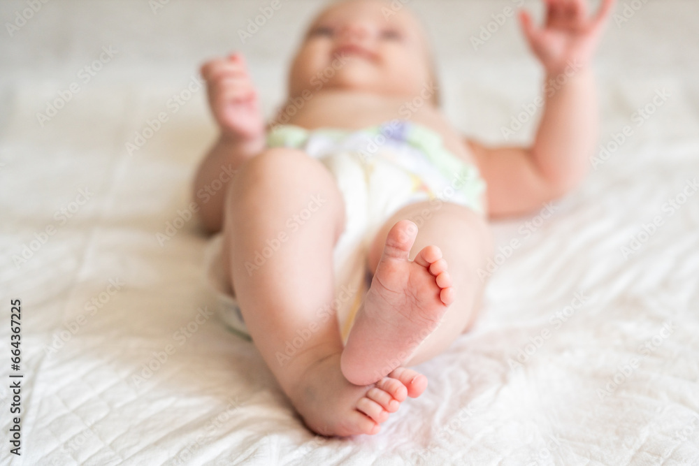 Newborn feet, center of attraction on a bed. Concept of embracing life's simplicity Newborn feet, center of attraction on a bed. Concept of embracing life's simplicity