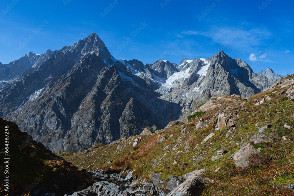 The panorama of Val Ferret, one of the wildest and most spectacular areas of the Italian Alps, near the town of Courmayeur, Valle d'Aosta, Italy - October 2, 2023.