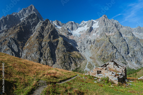 The panorama of Val Ferret, one of the wildest and most spectacular areas of the Italian Alps, near the town of Courmayeur, Valle d'Aosta, Italy - October 2, 2023.