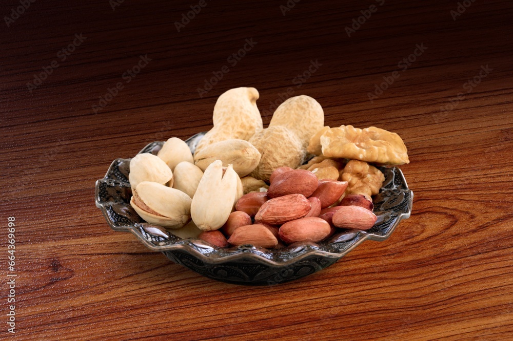Mix of tasty dry nuts and fruits on the desk Mix of tasty dry nuts and fruits on the desk