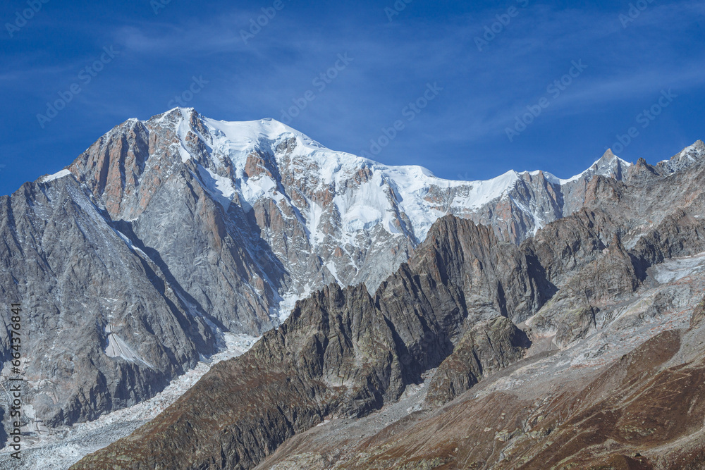 Mont Blanc, the highest top of the Alps, seen by the paths of the Val Ferret, during a sunny October day, near the town of Courmayeur, Valle d'Aosta, Italy - October 2023