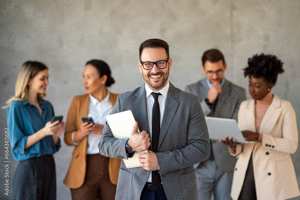 Portrait of multiethnic group of diverse corporate colleagues standing in a row at modern office Portrait of multiethnic group of diverse corporate colleagues standing in a row at modern office
