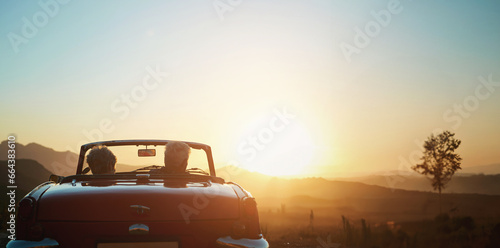 Back, sunset and a senior couple on a road trip in a convertible car for travel, freedom or adventure together. Love, mockup or view of nature with an elderly man and woman in a vehicle for a drive photo