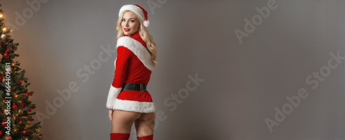Smiling beautiful Caucasian American woman in Santa clothes on a Christmas background illustration. New Year's celebration with copy space.