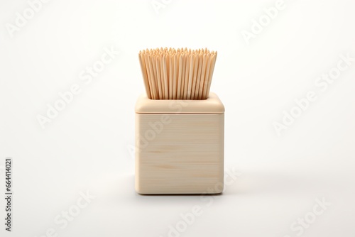 Toothpicks in a toothpick holder, isolated on a white background © Tarun