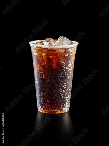 Cola soda on disposable plastic cup. Studio Shoot isolated on black background.