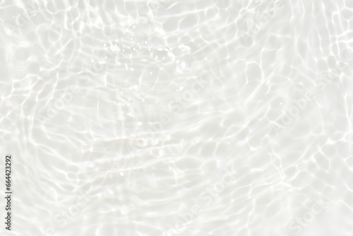 Defocus blurred transparent white colored clear calm water surface texture with splashes reflection. Trendy abstract nature background. Water waves in sunlight with copy space. Blue watercolor shine.