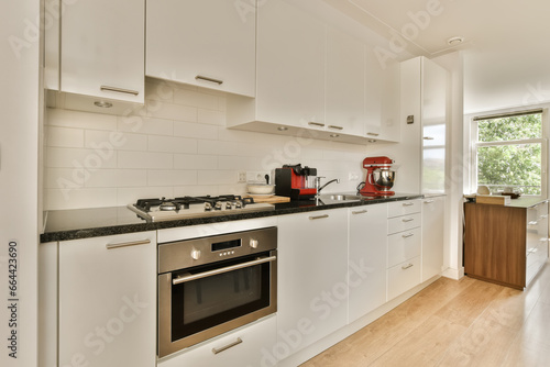 a kitchen with white cupboards and appliances on the counter top in front of the oven, sink and dishwasher