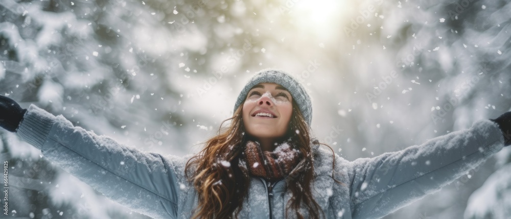 low angle Woman with arms outstretched in snow low angle Woman with arms outstretched in snow