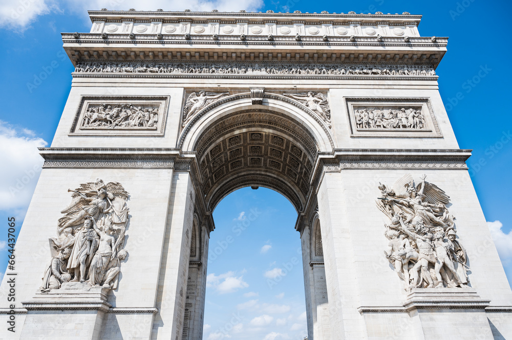 Arc de Triomphe, one of the most famous monuments in Paris, massive triumphal arch, located near Champs-Elysees in Paris. Close up, selective focus