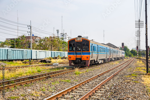 Classic diesel trains transport passengers and tourists in Thailand at railway junctions.