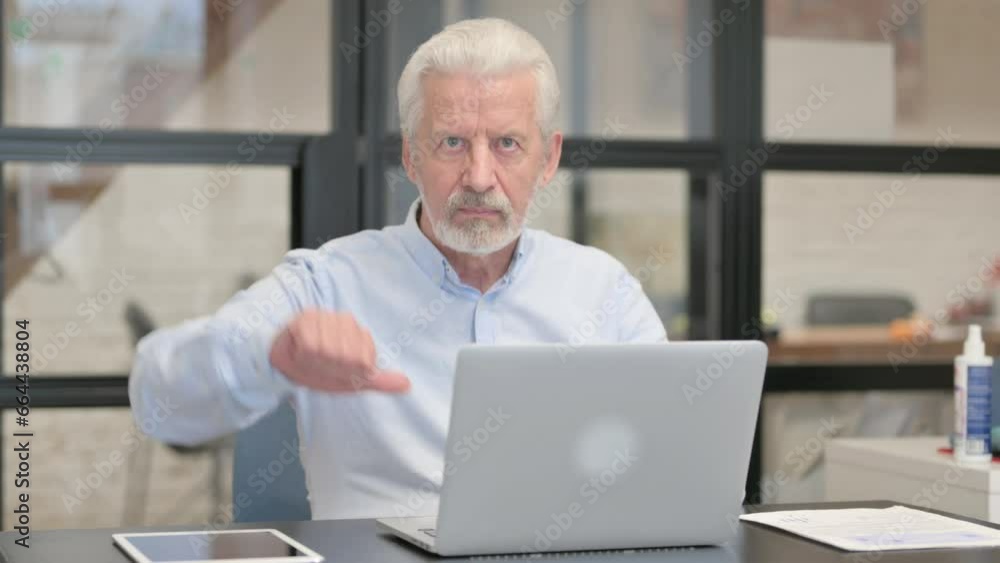 Thumbs Down by Old Man Using Laptop Thumbs Down by Old Man Using Laptop