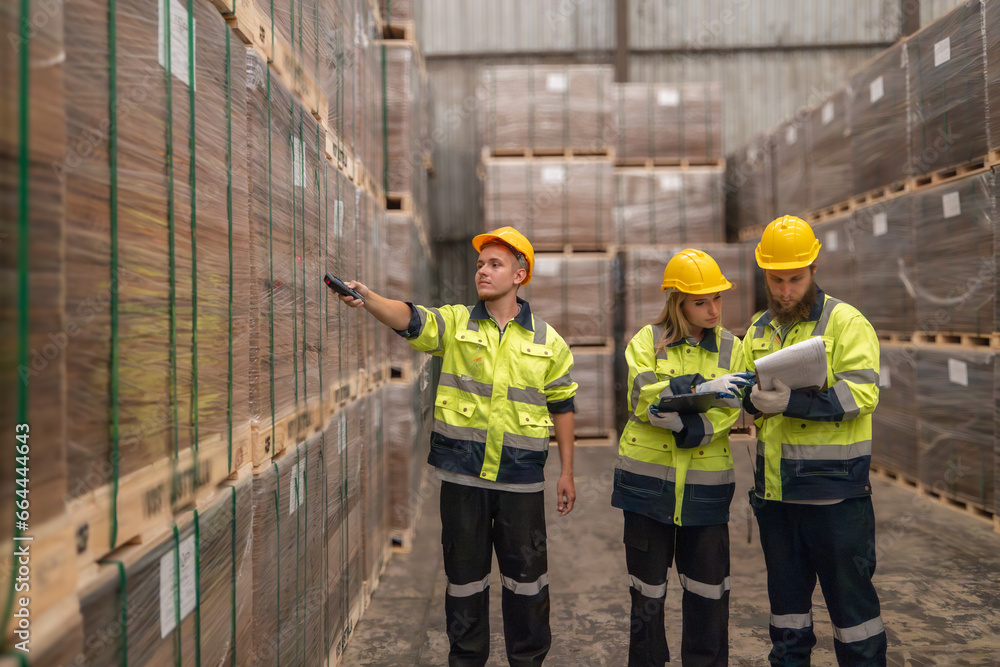 Warehouse staff verify wooded pallets items using handheld device, ensuring precise shipment. Warehouse staff verify wooded pallets items using handheld device, ensuring precise shipment.