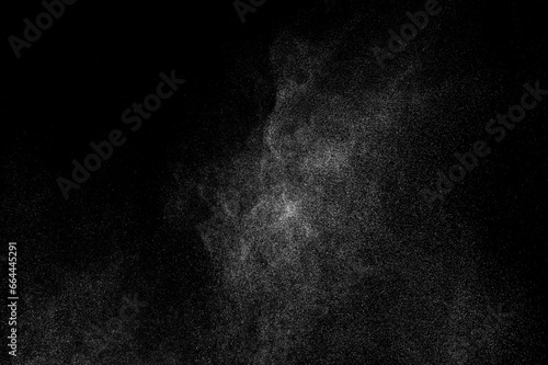 Abstract splashes of water on black background. Freeze motion of white particles. Rain, snow overlay texture. 