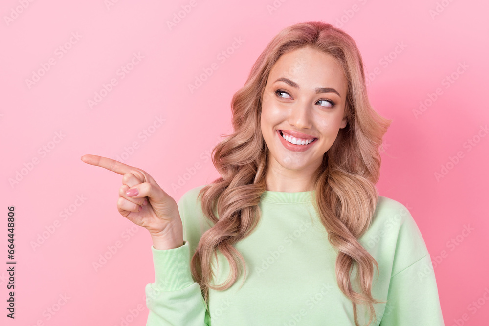 Photo of stunning positive person beaming smile look indicate finger empty space isolated on yellow color background Photo of stunning positive person beaming smile look indicate finger empty space isolated on yellow color background