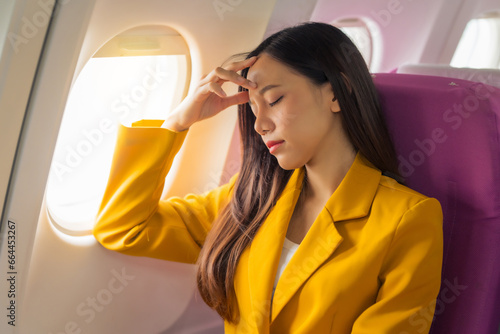Εκτύπωση καμβά Young asian chinese airplane passenger woman experiencing discomfort, Airplane headache