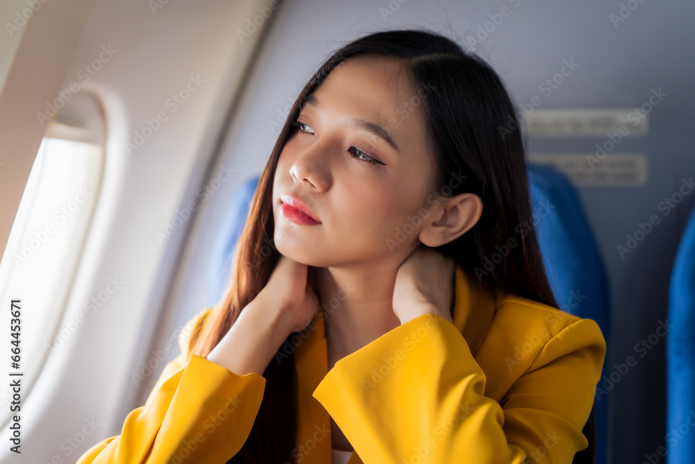 Young asian chinese airplane passenger woman experiencing discomfort, Airplane headache. Worried female passenger holding head, feeling unwell Anxiety and fear in the skies. Stressful travel moments. Young asian chinese airplane passenger woman experiencing discomfort, Airplane headache. Worried female passenger holding head, feeling unwell Anxiety and fear in the skies. Stressful travel moments.